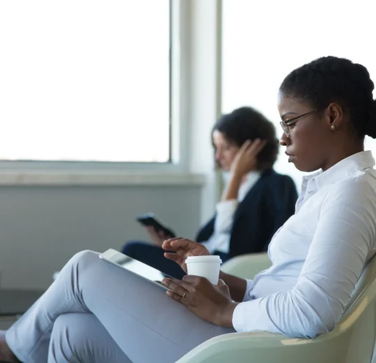 young-female-manager-reading-news-tablet